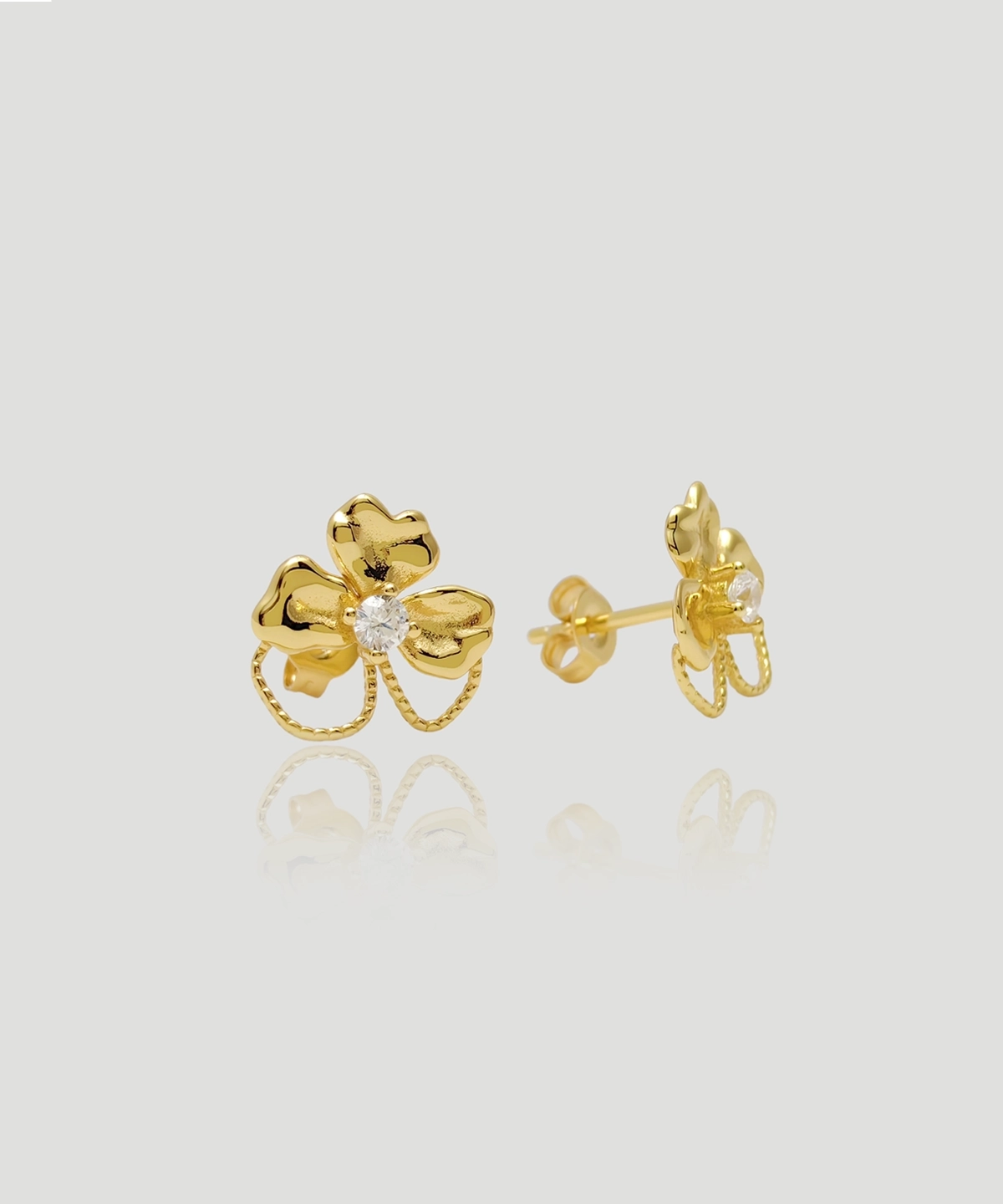 This image is the main picture of the Luck-Sterling Silver Gold-Plated Flower Stud Earrings, showcasing the front and side views of the "Luck" earrings. These earrings are made from sterling silver and plated with gold. The overall shape of the earrings resembles a three-leaf clover, with a sparkling 5A-grade zirconia stone at the center of each clover. The back of the earrings features standard ear studs, ensuring secure and comfortable wear. They are suitable for everyday wear or as a gift.