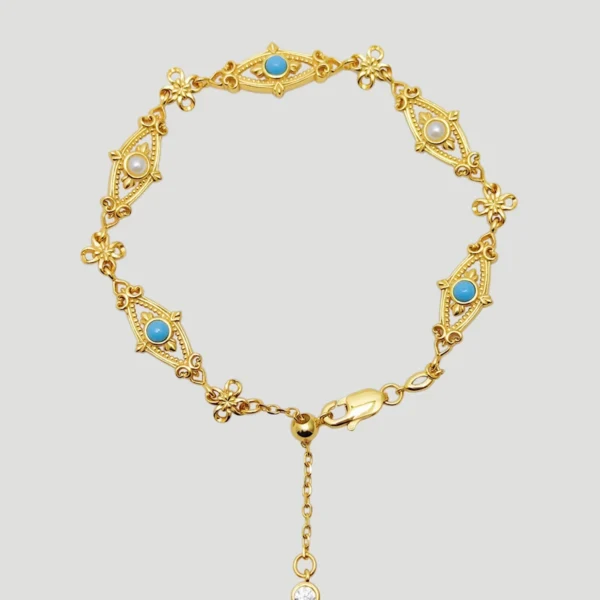 This image showcases an adjustable Evil Eye Bracelet. The bracelet features multiple "evil eye" elements, each with a natural turquoise or pearl at the center. The "evil eye" elements are surrounded by intricate patterns, giving the bracelet a classical and elegant style. The bracelet ends with an adjustable chain, which has a small diamond pendant at the end, adding a touch of luxury. The design of the bracelet makes it suitable for everyday wear as well as for formal occasions such as dinners and parties, making it an ideal jewelry gift.