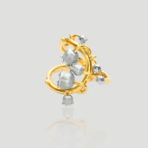 The image shows a beautifully crafted ring named Ethereal Bells | Sterling Silver Lily Of The Valley Ring. The ring features a unique design with a combination of gold-plated and sterling silver elements. The main structure of the ring is gold-plated, forming an intricate, looping pattern. Attached to this gold-plated structure are several sterling silver elements shaped like lily of the valley flowers, which are small, bell-shaped blooms. The silver flowers are distributed evenly around the gold-plated loops, creating a harmonious and elegant appearance. The ring's design is both delicate and sophisticated, making it a striking piece of jewelry.