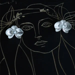 Butterfly Orchid Earrings | 925 Sterling Silver Floral Studs capture the essence of delicate floral beauty. Crafted from high-quality sterling silver, these nature-inspired earrings feature intricately detailed orchid petals with a radiant central bead. Their artistic presentation—set against a minimalist face illustration with floral sketches—enhances their elegant allure. Lightweight and hypoallergenic, they blend sophistication with comfort, perfect for daily wear or special occasions. Whether gifted to a nature enthusiast or worn as a statement piece, these earrings embody timeless craftsmanship and botanical charm. Elevate your jewelry collection with these exquisite floral studs.