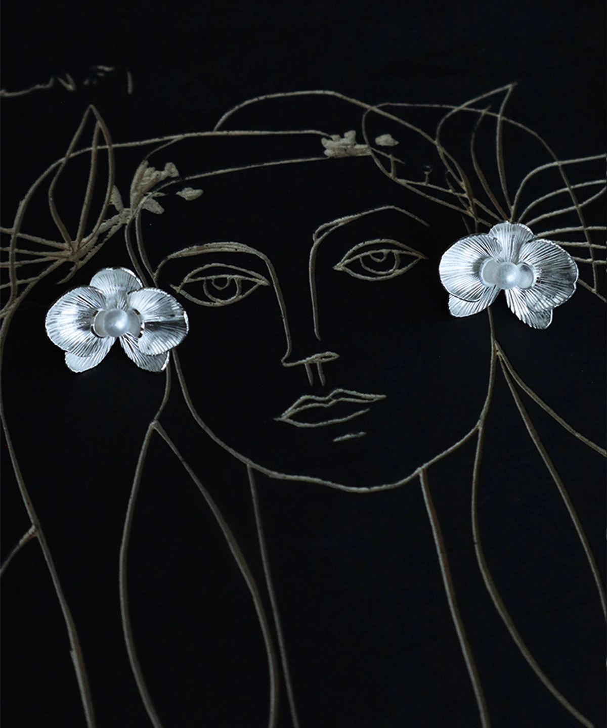 Butterfly Orchid Earrings | 925 Sterling Silver Floral Studs capture the essence of delicate floral beauty. Crafted from high-quality sterling silver, these nature-inspired earrings feature intricately detailed orchid petals with a radiant central bead. Their artistic presentation—set against a minimalist face illustration with floral sketches—enhances their elegant allure. Lightweight and hypoallergenic, they blend sophistication with comfort, perfect for daily wear or special occasions. Whether gifted to a nature enthusiast or worn as a statement piece, these earrings embody timeless craftsmanship and botanical charm. Elevate your jewelry collection with these exquisite floral studs.
