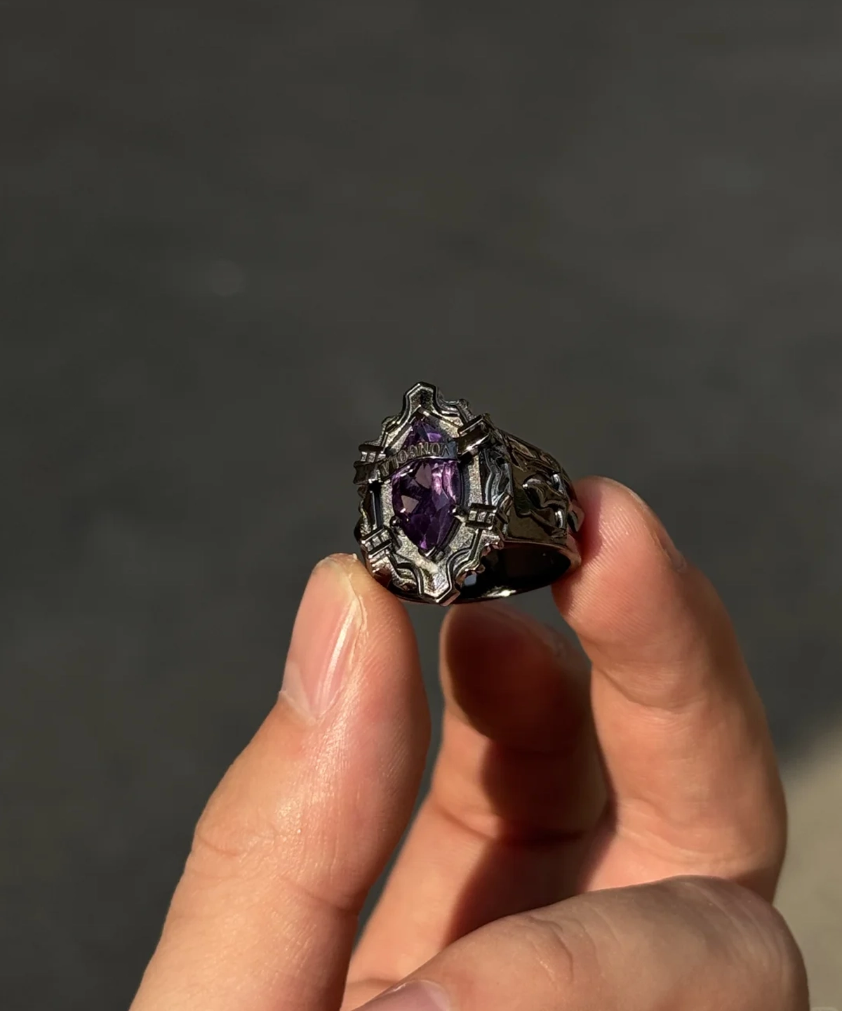 The image features a stunning, handmade sterling silver ring inspired by the anime Katekyo Hitman Reborn! This exquisite piece, named the "Vongola Ring," showcases an intricate design that pays homage to Kyoya Hibari’s iconic Vongola Cloud Ring. The ring's band is meticulously crafted with sharp, angular patterns that evoke a bold and edgy aesthetic, true to the character's fierce personality. At its center lies an intricate emblem resembling the Cloud Flame crest, symbolizing strength and independence. The polished silver finish enhances its striking appearance, making it a standout piece of handmade anime jewelry. This Katekyo Hitman Reborn Ring is ideal for fans of the series and collectors of unique Vongola Rings alike.