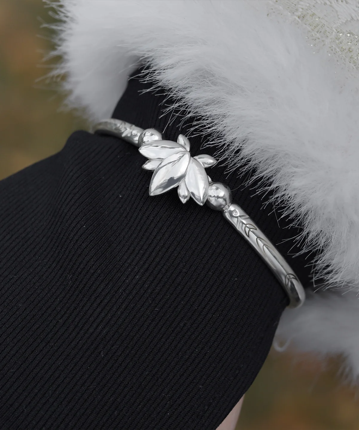The Lazesoul Handmade Anime Jewelry — 999 Pure Silver Open Adjustable Bangle, Frieren: Beyond Journey's End Mirror Lotus Bracelet, shines in its Polished Finish. The image captures it worn on a wrist, elegantly framed by a black sleeve and a soft white cuff, enhancing its refined brilliance. The sculpted lotus centerpiece and intricate engravings reflect anime artistry and fine craftsmanship. Designed for collectors and fans, this adjustable silver bangle adds a sophisticated touch to daily wear or cosplay. Set against an outdoor backdrop, the bracelet’s radiant surface gleams naturally, emphasizing purity and elegance—an essential piece for anime-inspired luxury accessories.