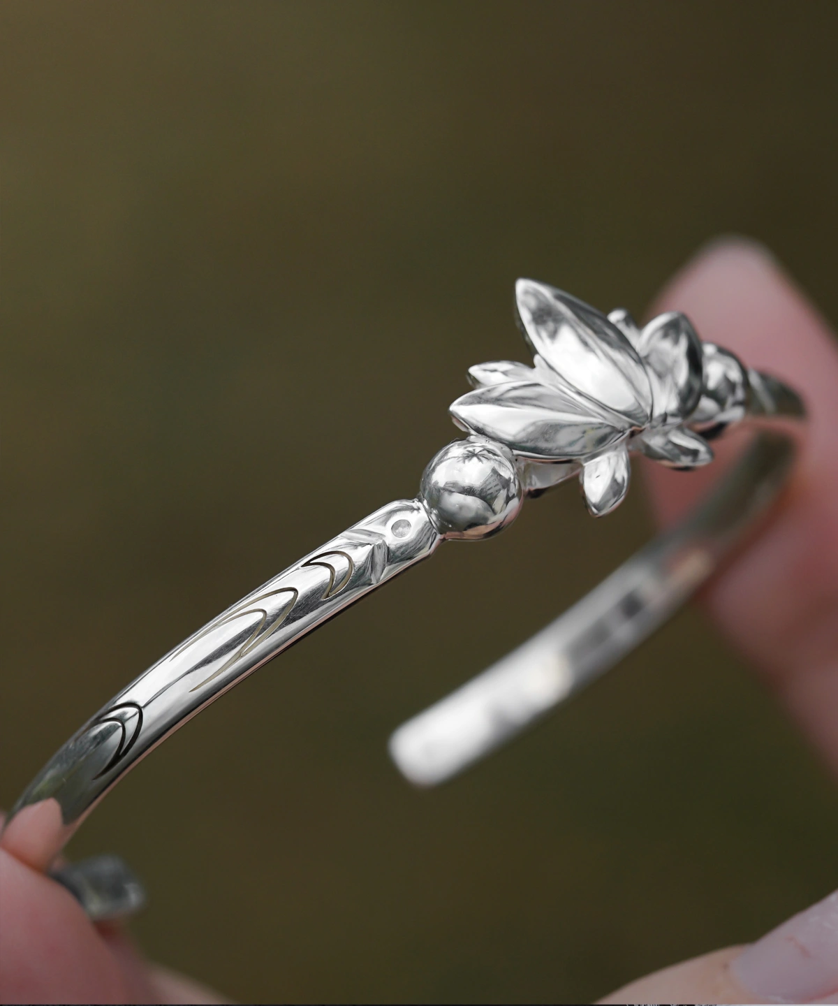 The Lazesoul Handmade Anime Jewelry — 999 Pure Silver Open Adjustable Bangle, inspired by Frieren: Beyond Journey's End, embodies elegance and artistry. The bracelet features a sculpted lotus motif, symbolizing wisdom and renewal, with intricate engravings accentuating its refined craftsmanship. Designed for anime collectors and jewelry enthusiasts, its adjustable open design ensures a comfortable fit. Set against a soft-focus backdrop, the image highlights the bangle’s polished texture, emphasizing its premium quality. Ideal for cosplay or daily wear, this anime-inspired luxury accessory adds sophistication to any look.