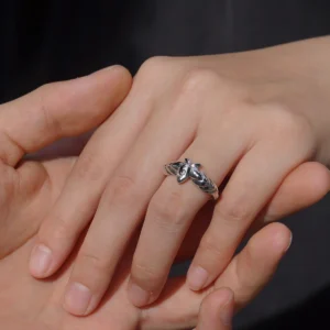 A close-up captures a tender moment as one hand gently slips the Lazesoul Handmade Mirror Lotus Ring onto another. Crafted from 999 pure silver, this open adjustable ring draws inspiration from Frieren: Beyond Journey’s End, featuring a stylized lotus motif with anime charm. Ideal for fans of fantasy jewelry and meaningful gifts.
