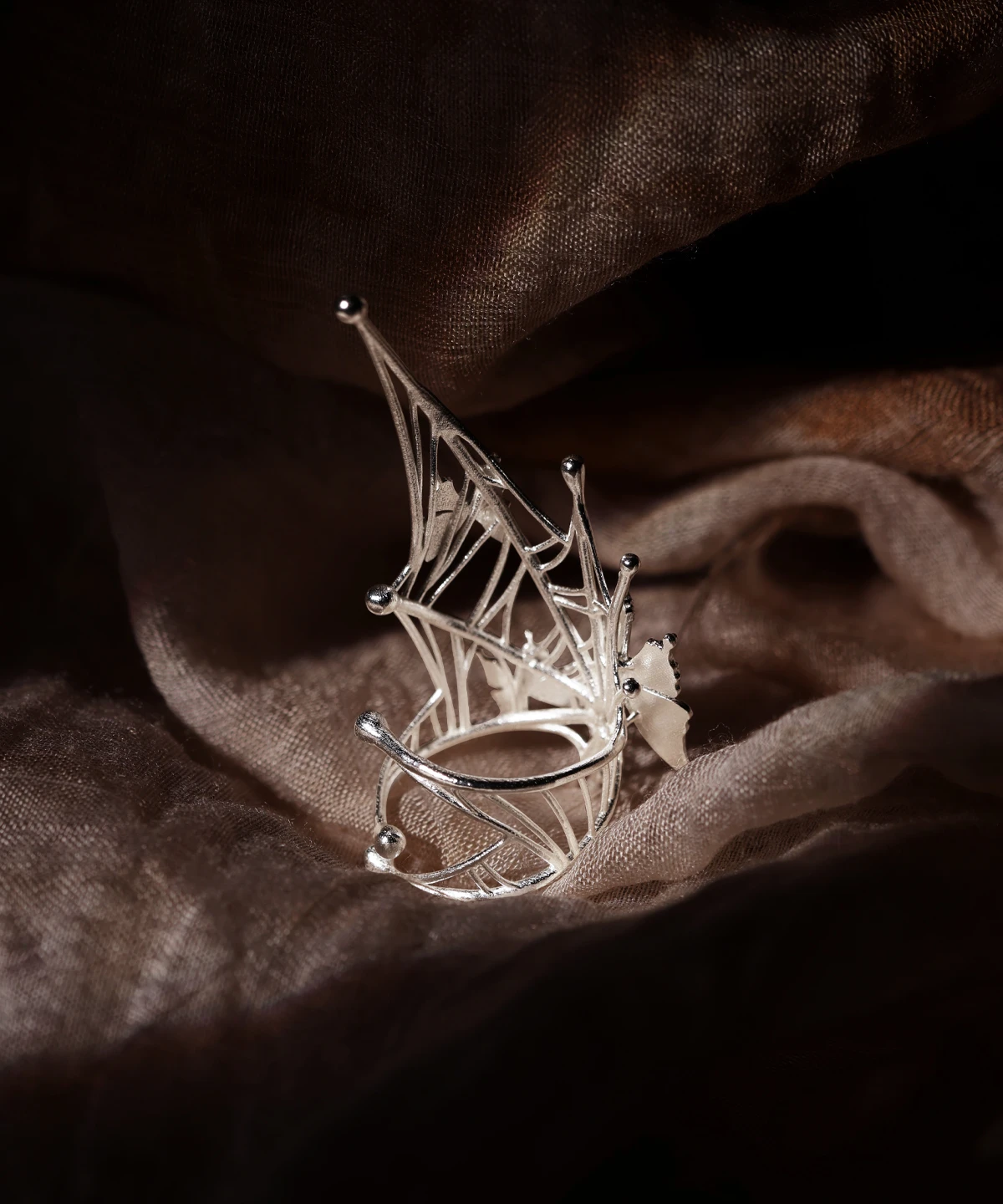 Close-up view of the inner wall of our Butterfly Ring in 925 Sterling Silver | Art Fantasy Pinky Ring. The image highlights intricate engravings featuring delicate butterfly motifs intertwined with subtle web-like patterns, showcasing exceptional artisanal craftsmanship. This hidden detail adds an exclusive touch to a unique accessory, making it ideal for trendsetters seeking modern elegance with a fantasy-inspired twist.