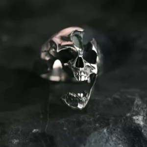 A close-up of the Dark Skull Ring crafted from S925 silver, featuring an intricately detailed skull design with an open jaw and a gemstone inlay. The ring's bold, dark aesthetic enhances its edgy appeal, making it a striking accessory.
