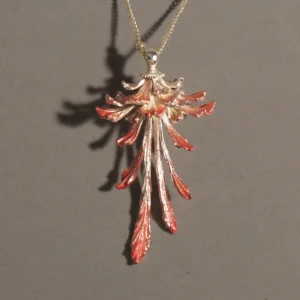 Drooping Blossom | 925 Sterling Silver Long Necklace features a stunning floral pendant with cascading, elongated petals that shift from a luminous metallic silver to rich reddish-orange tips. Suspended from a sleek sterling silver chain and set against a dark, textured backdrop, this statement piece exudes refined elegance and modern sophistication. Ideal for both formal occasions and everyday wear, it highlights exceptional craftsmanship and timeless allure.