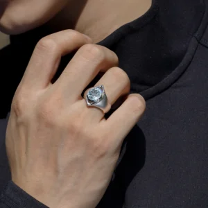 Close-up of a hand wearing the Six Eyes Ring in Sterling Silver with a Natural Topaz gemstone, inspired by Gojo Satoru, against a dark background.