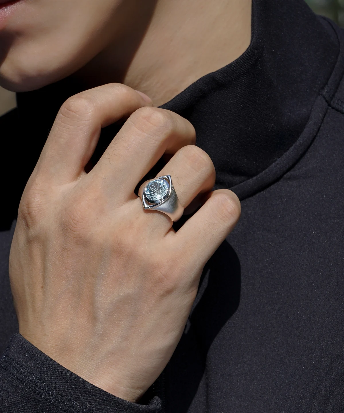 Close-up of a hand wearing the Six Eyes Ring in Sterling Silver with a Natural Topaz gemstone, inspired by Gojo Satoru, against a dark background.