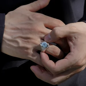 Close-up of hands holding a Six Eyes Ring in Sterling Silver with Natural Topaz, showcasing intricate design inspired by Gojo Satoru from anime.