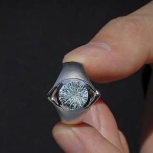 Six Eyes Ring in Sterling Silver with Natural Topaz, resting elegantly on an open palm against a dark backdrop, highlighting its intricate craftsmanship.