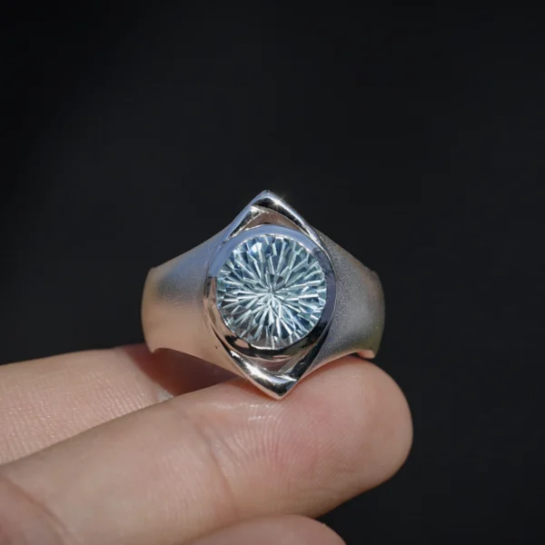Home 61 Six Eyes Ring in Sterling Silver with Natural Topaz, resting elegantly on an open palm against a dark backdrop, highlighting its intricate craftsmanship.