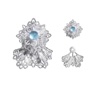 A pair of snowflake earrings, crafted in 925 sterling silver, featuring an intricate lace-like design. Adorned with shimmering Sky Blue gemstones, the earrings capture the icy brilliance of winter’s beauty. The image also showcases the earrings' detachable components, highlighting their versatile styling options.