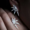 A close-up of the Dancing Petals-Organic Sterling Silver Statement Earrings, featuring their fluid, nature-inspired petal design handcrafted in S925 sterling silver.