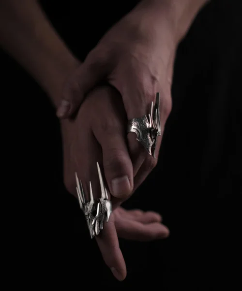 Close-up of hands wearing the Dark Lord Ring for Men, a 925 Sterling Silver Gothic Armor Ring inspired by Sauron from The Lord of the Rings.