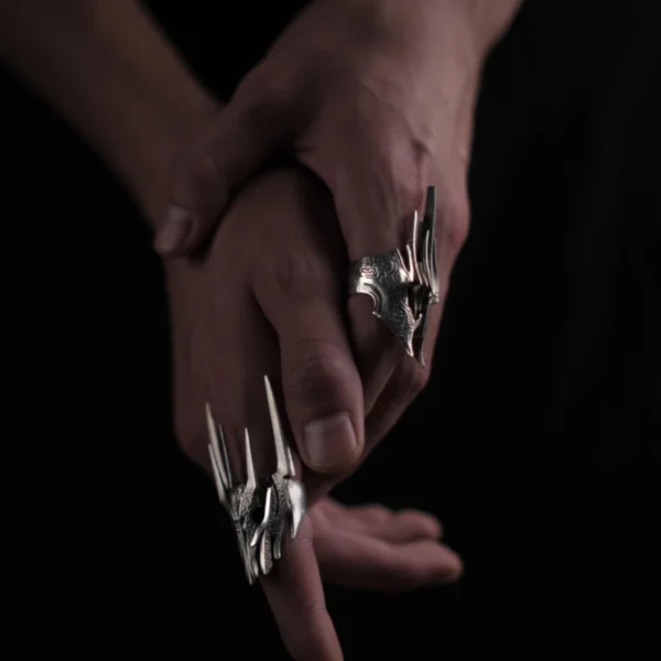 Close-up of hands wearing the Dark Lord Ring for Men, a 925 Sterling Silver Gothic Armor Ring inspired by Sauron from The Lord of the Rings.