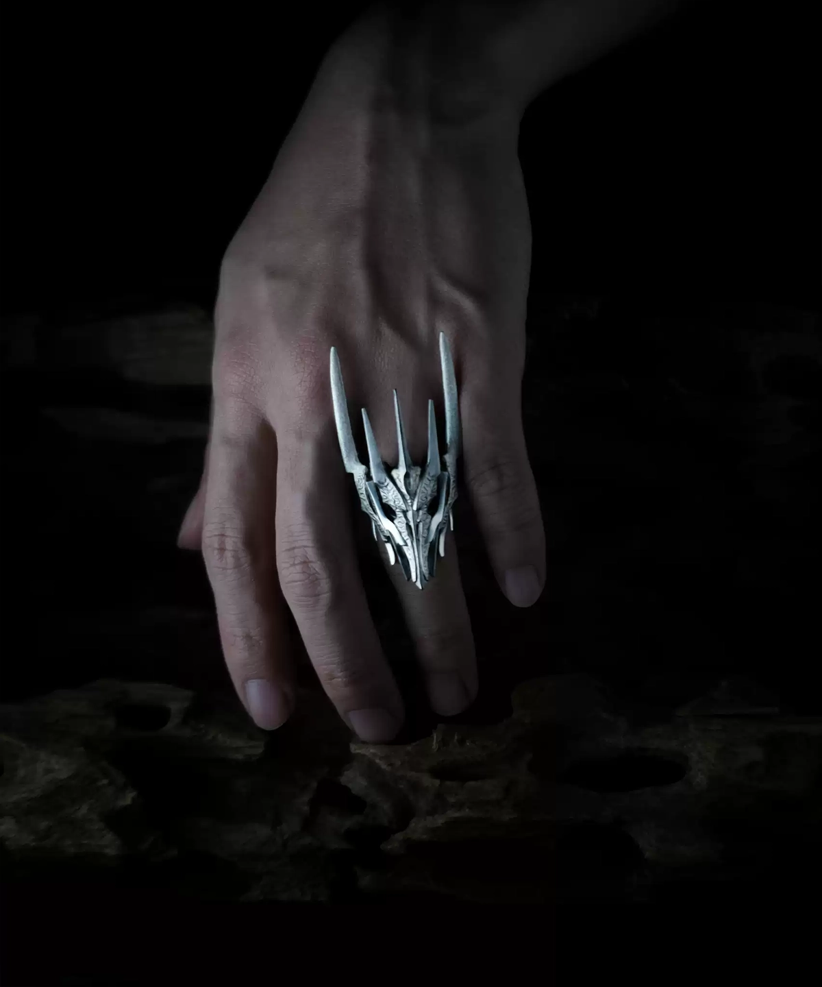 A hand wearing the Dark Lord Ring for Men, a 925 Sterling Silver Gothic Armor Ring inspired by Sauron from The Lord of the Rings. The ring features intricate, spiked designs resembling armor.