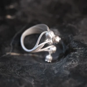 A close-up image of a Lily of the Valley Ring made from S925 sterling silver. The ring features delicate, handcrafted lily of the valley flowers and an adjustable open design.