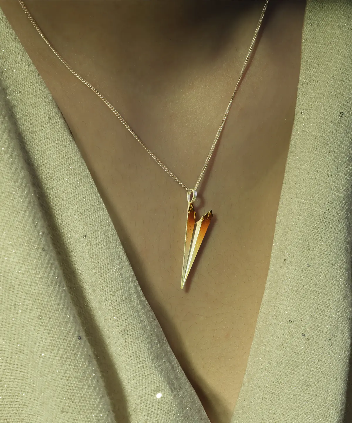 A close-up of a Paper Airplane Necklace crafted in S925 Sterling Silver, featuring a delicate, minimalist design that mimics the iconic shape of a folded paper airplane. The pendant hangs gracefully from an adjustable chain, reflecting light beautifully, making it a stylish and meaningful accessory for everyday wear.