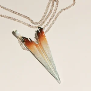 A handcrafted S925 sterling silver paper airplane necklace, featuring an elegant gradient design transitioning from deep brown to bright silver. The pendant is suspended from a stylish double chain, enhancing its modern and artistic aesthetic.