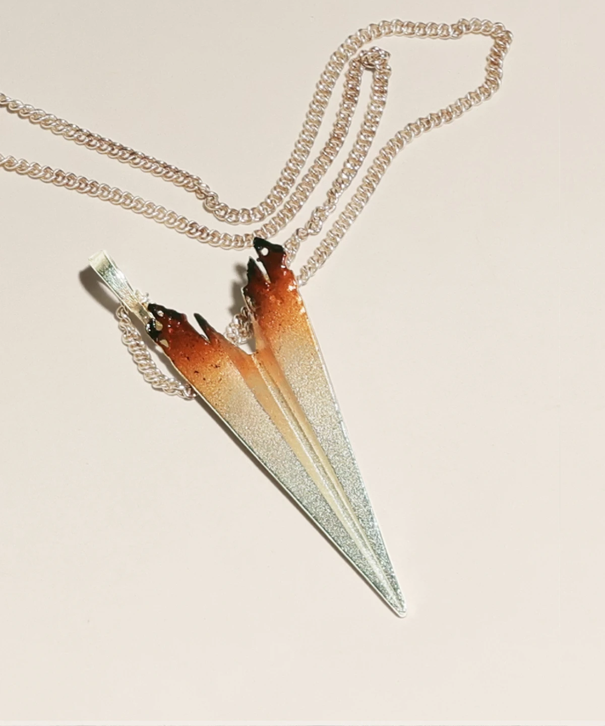 A handcrafted S925 sterling silver paper airplane necklace, featuring an elegant gradient design transitioning from deep brown to bright silver. The pendant is suspended from a stylish double chain, enhancing its modern and artistic aesthetic.