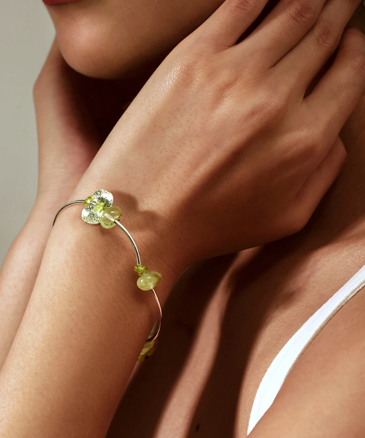 Close-up of a woman wearing the Prelude Summer Peridot Bracelet by Lazesoul, handcrafted from S925 sterling silver with natural prehnite and peridot stones. A delicate, nature-inspired design perfect for summer elegance.