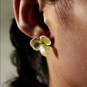 A close-up of a woman wearing Lazesoul's Prelude Summer natural peridot earrings in sterling silver, handcrafted with S925 silver and featuring luminous green prehnite and peridot gemstones.