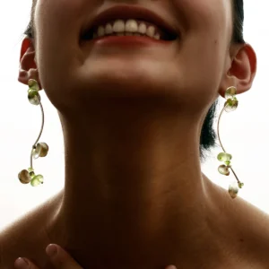 A close-up of Lazesoul’s handmade Prelude Summer Peridot Earrings featuring S925 sterling silver, natural prehnite, and vibrant peridot stones in an elegant curved design. Sophisticated summer jewelry.