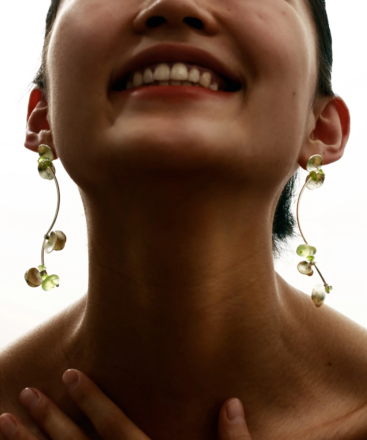 A close-up of Lazesoul’s handmade Prelude Summer Peridot Earrings featuring S925 sterling silver, natural prehnite, and vibrant peridot stones in an elegant curved design. Sophisticated summer jewelry.