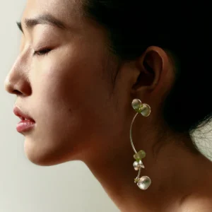 A close-up of a model wearing Lazesoul’s handmade Prelude Summer earrings in S925 sterling silver, featuring elegant curves with natural prehnite and peridot gemstones—delicate, stylish Peridot Earrings for summer wear.