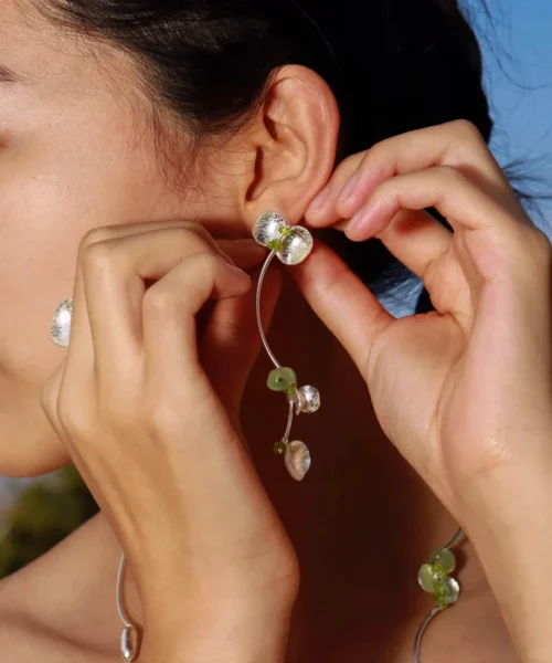 Close-up of a model wearing Lazesoul’s Prelude Summer Peridot Earrings featuring natural prehnite and green peridot stones set in S925 sterling silver; elegant and handcrafted summer jewelry.