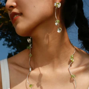 Model wearing Lazesoul’s Prelude Summer Peridot Earrings and matching necklace, handcrafted in sterling silver with natural green prehnite and peridot gemstones.
