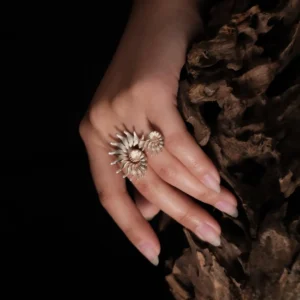 The Spiral Ring embodies modern artistry, seamlessly merging elegance with craftsmanship. Handmade in S925 sterling silver, this design ring features a sculptural spiral motif, creating a striking visual flow. The close-up image captures the ring’s refined details, worn gracefully on the hand, with a natural wooden texture enhancing its organic aesthetic. A statement piece designed for those who appreciate timeless sophistication and intricate design.