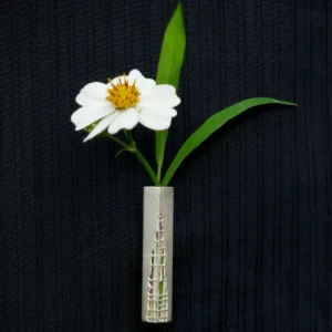 Handmade 925 sterling silver brooch featuring an intricately crafted silver frame, displayed alongside a fresh white flower with a yellow center.