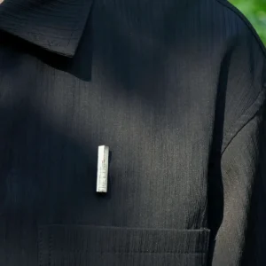 Handmade 925 sterling silver brooch pinned on a black shirt, showcasing its minimalist and nature-inspired design.