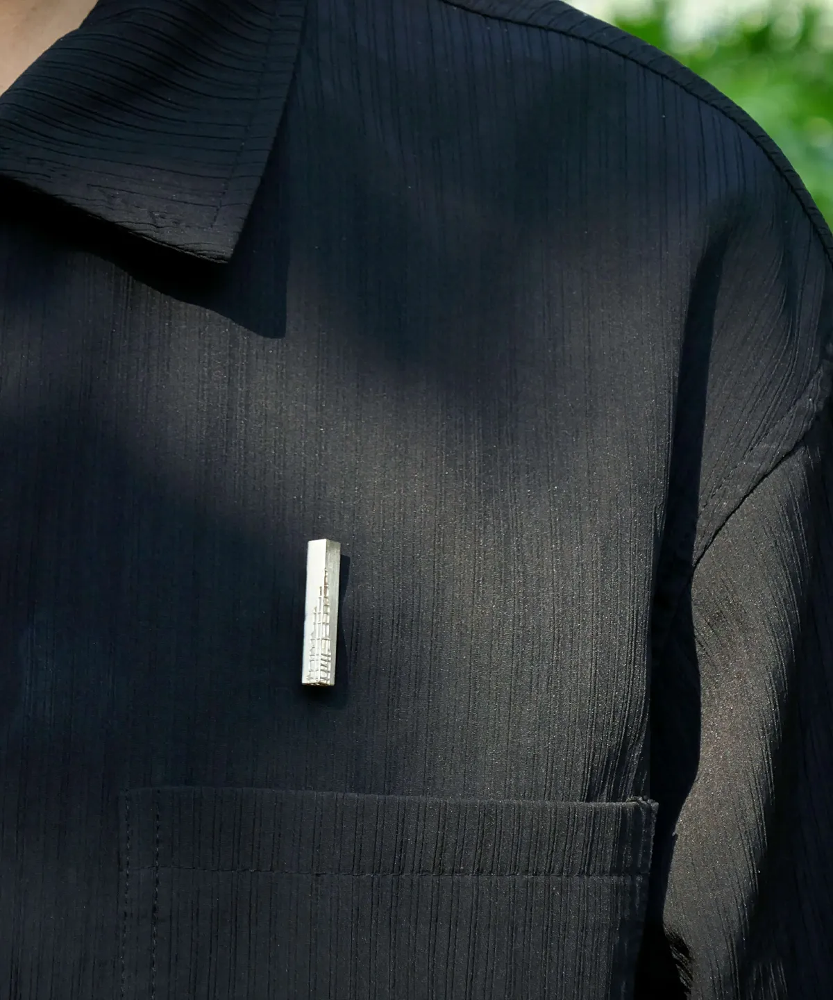 Handmade 925 sterling silver brooch pinned on a black shirt, showcasing its minimalist and nature-inspired design.