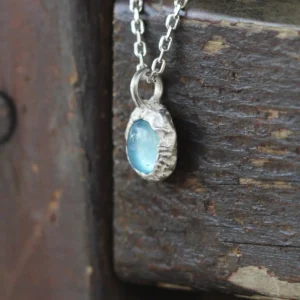 Close-up view of the Lazesoul Handmade S925 Sterling Silver Natural Aquamarine Necklace featuring a soft blue aquamarine gemstone pendant on a delicate silver chain.