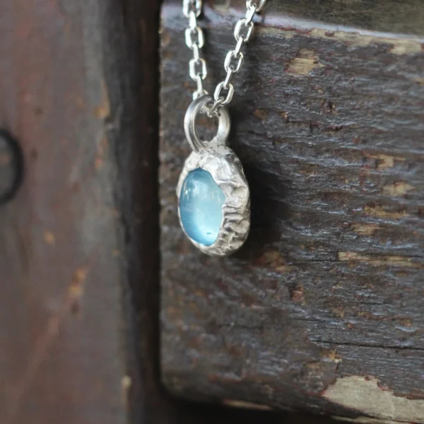 925 Silver Natural Aquamarine Necklace 06 Close-up view of the Lazesoul Handmade S925 Sterling Silver Natural Aquamarine Necklace featuring a soft blue aquamarine gemstone pendant on a delicate silver chain.