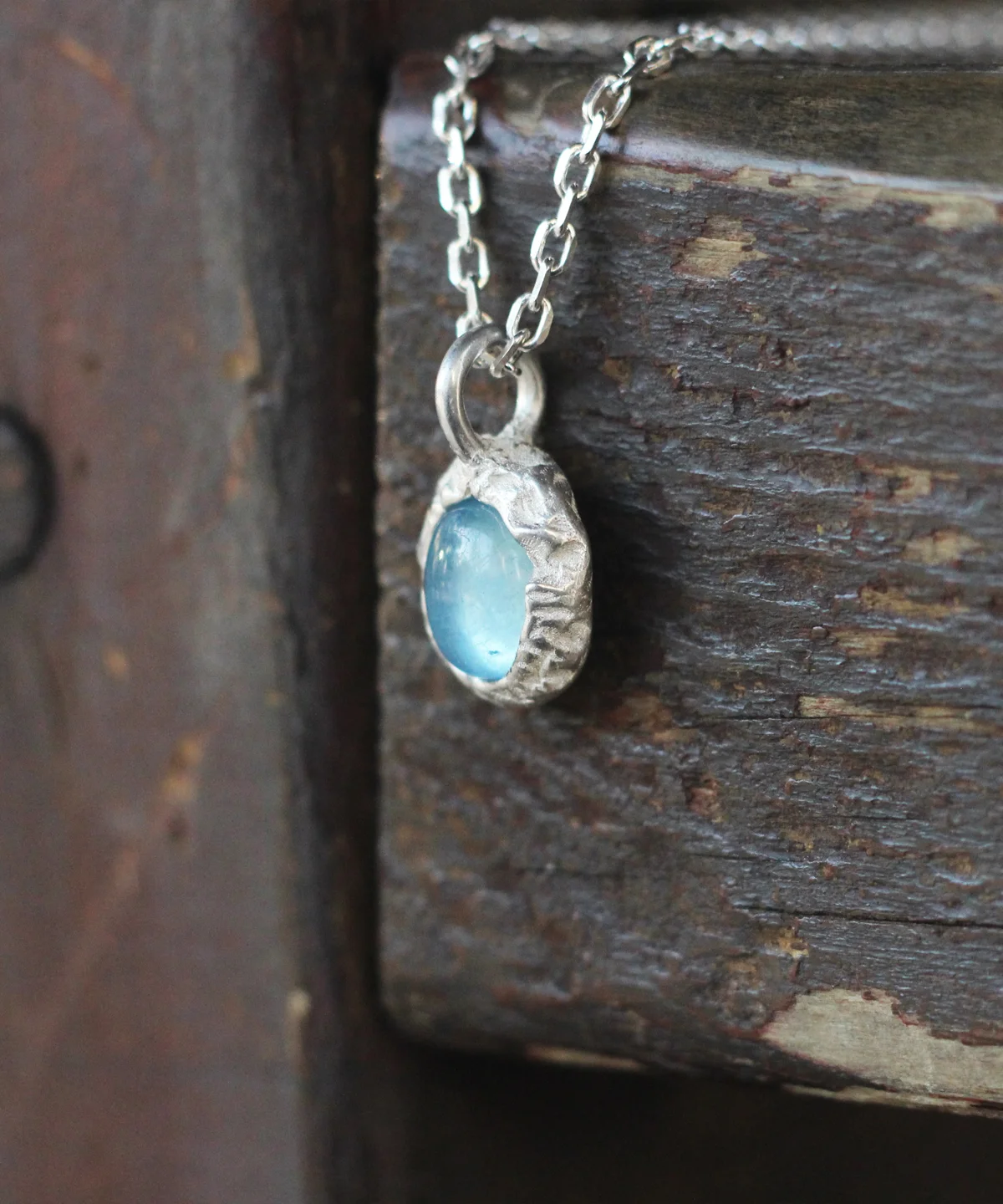 Close-up view of the Lazesoul Handmade S925 Sterling Silver Natural Aquamarine Necklace featuring a soft blue aquamarine gemstone pendant on a delicate silver chain.