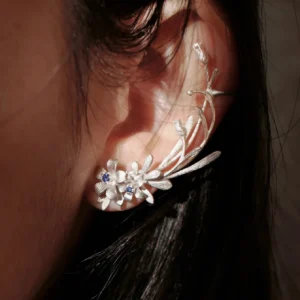 Lily Earrings in S925 sterling silver, featuring a delicate stud and ear cuff design with lab-created sapphire accents, styled on-ear to highlight Lazesoul’s handmade floral craftsmanship.