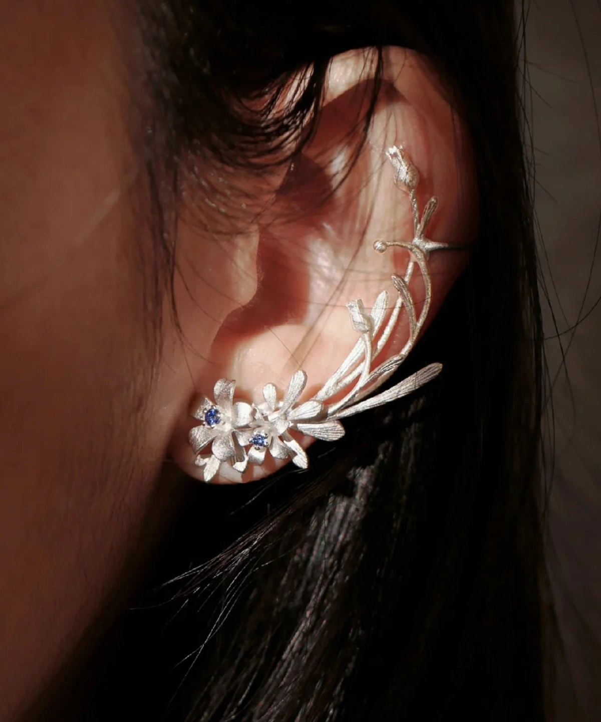 Lily Earrings in S925 sterling silver, featuring a delicate stud and ear cuff design with lab-created sapphire accents, styled on-ear to highlight Lazesoul’s handmade floral craftsmanship.