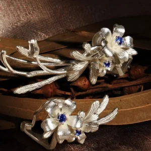 Lily Earrings crafted in S925 sterling silver with lab-created sapphire details, featuring a delicate floral motif in both stud and ear cuff styles from Lazesoul Handmade Natural Jewelry.
