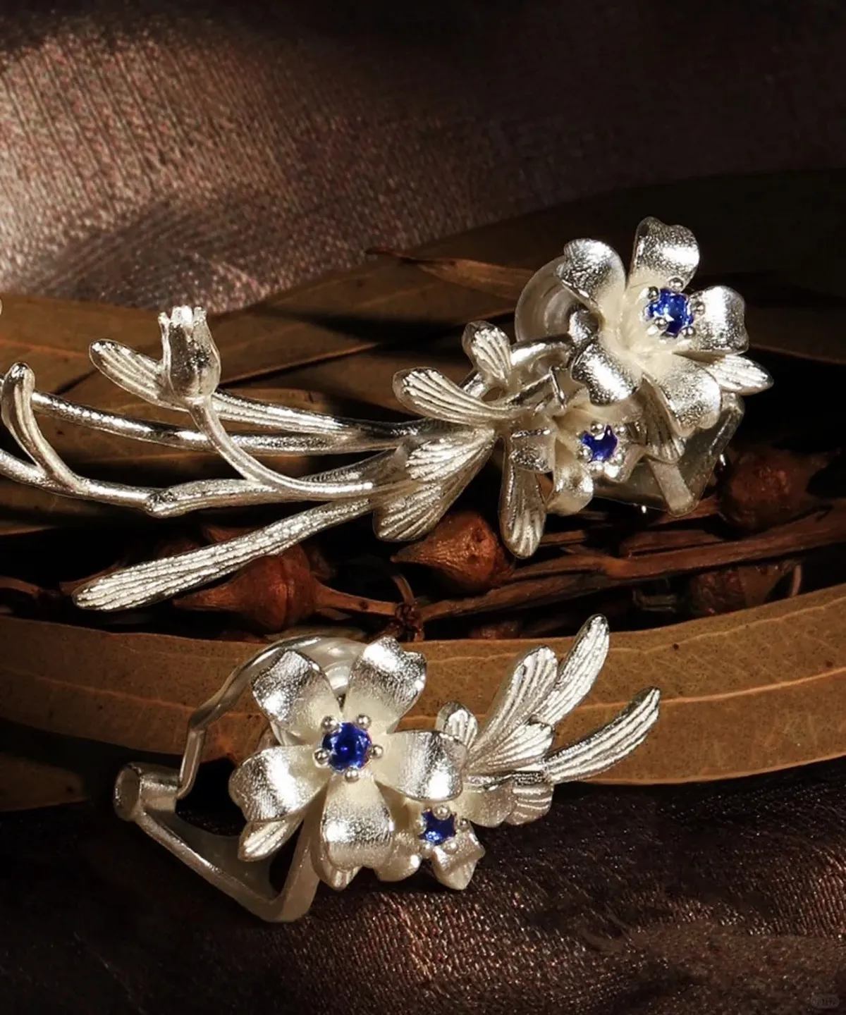 Lily Earrings crafted in S925 sterling silver with lab-created sapphire details, featuring a delicate floral motif in both stud and ear cuff styles from Lazesoul Handmade Natural Jewelry.