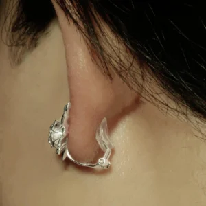 Close-up of ear wearing Lazesoul’s Lily Earrings-S925 Sterling Silver Ear Cuff, featuring delicate lily design and shimmering lab-created sapphire—nature-inspired handmade jewelry.