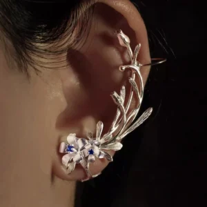 Close-up of an ear wearing Lazesoul’s handmade Lily Earrings, crafted in S925 sterling silver with intricate lily-shaped details and shimmering lab-created sapphires. Elegant ear cuff highlights floral artistry and natural elegance.