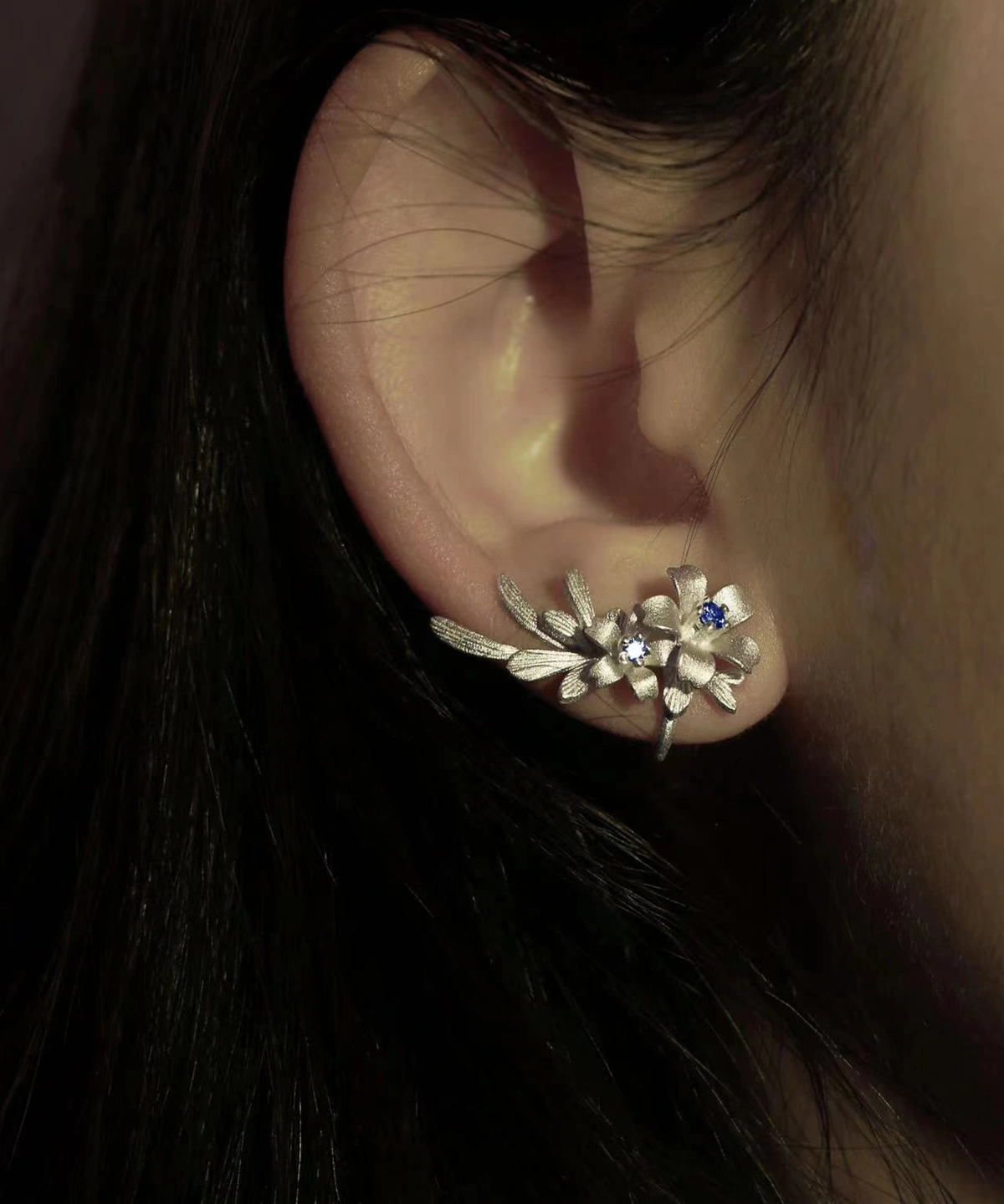 Lily Earrings in S925 sterling silver styled as ear cuffs, featuring elegant floral detailing and shimmering lab-created sapphire stones. Handmade by Lazesoul, highlighting natural beauty and craftsmanship.