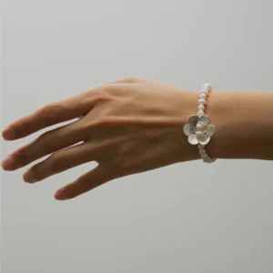Hand wearing Lazesoul's Little Flower Beaded Bracelet crafted in S925 sterling silver with natural freshwater pearls and floral accents. A delicately handmade Beaded Ring style perfect for nature-inspired jewelry lovers.
