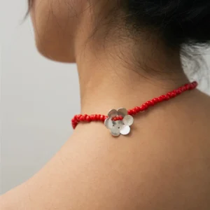 Close-up of Lazesoul Handmade Natural Jewelry’s Little Flower Beaded Necklace in S925 Sterling Silver, featuring red glaze beads. The delicate floral design and beadwork rest elegantly around the model’s neck, perfect for nature-inspired styling.
