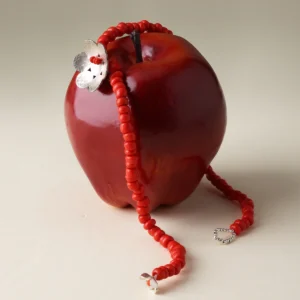 S925 sterling silver Little Flower Beaded Necklace displayed on a red apple; features handmade red glaze beads and floral charm, highlighting Lazesoul’s natural jewelry craftsmanship.